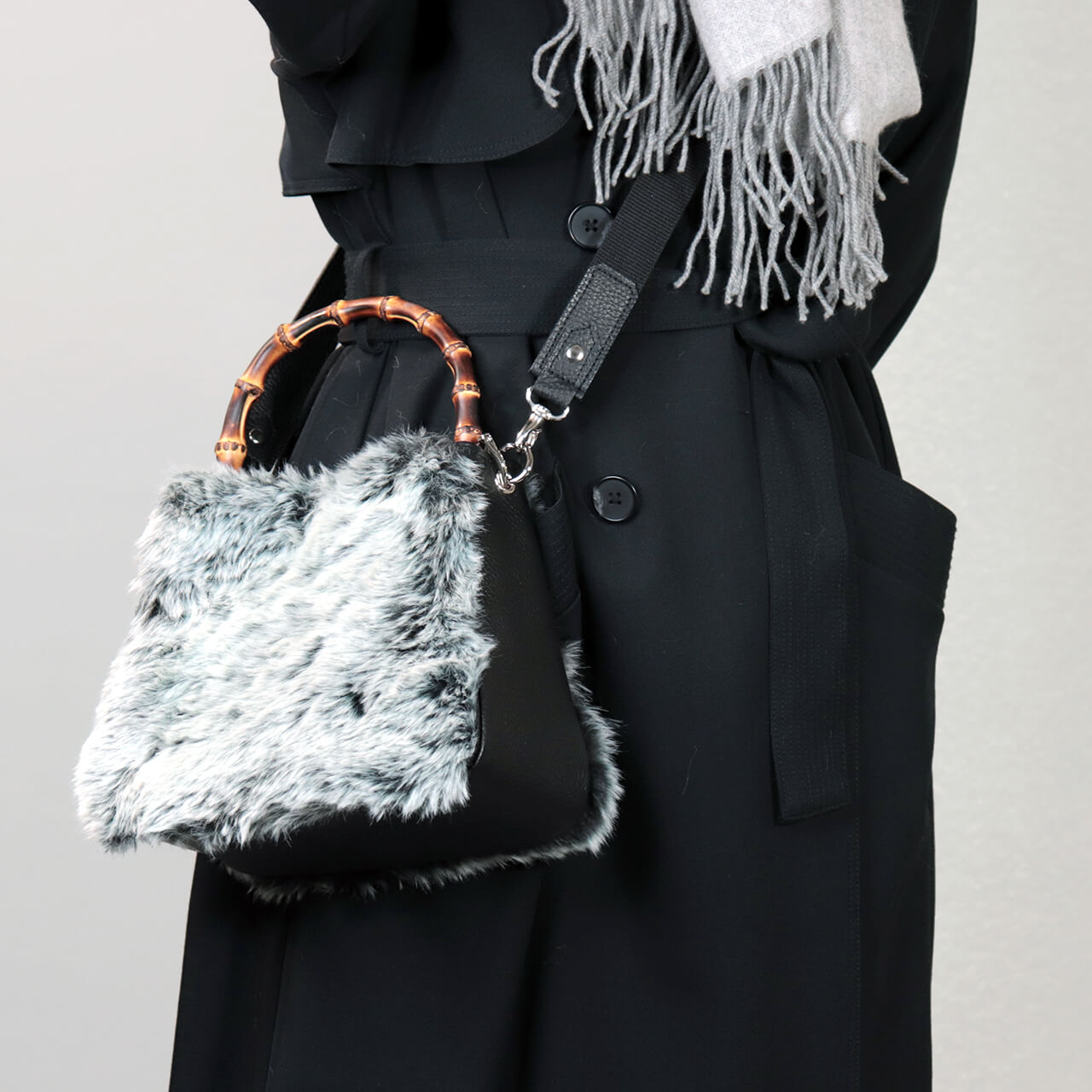 冬コーデに合わせた本革×グラデーションファーの2WAYミニトート【HOLLY・WEEKEND】を手に持つ女性。竹ハンドルが大人カジュアルを上品に見せるHANEANT KOBEのレザーバッグ。
